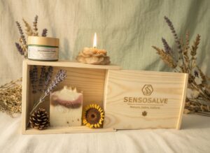 SENSOROOT pinewood gift box with SENSOBONHOMIE lavender bar soap, SENSOGOLDEN TRUTH beeswax flower candle, and SENSOAURELIAN tallow cream in frosted green glass jar with bamboo lid on vintage lavender cedarwood and sunflower background – natural skincare by Sensosalve Richmond BC 