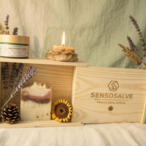 SENSOROOT pinewood gift box with SENSOBONHOMIE lavender bar soap, SENSOGOLDEN TRUTH beeswax flower candle, and SENSOAURELIAN tallow cream in frosted green glass jar with bamboo lid on vintage lavender cedarwood and sunflower background – natural skincare by Sensosalve Richmond BC